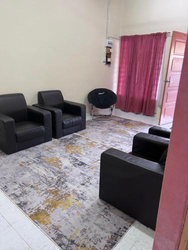 a living room with two chairs and a couch at imani homestay taman ira kangar perlis in Kangar