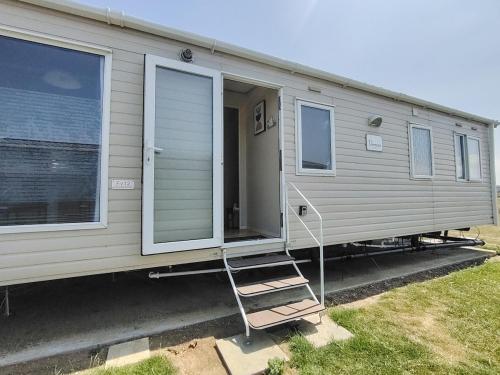 a mobile home with a ladder in front of it at The Victory Vermont in Leysdown-on-Sea