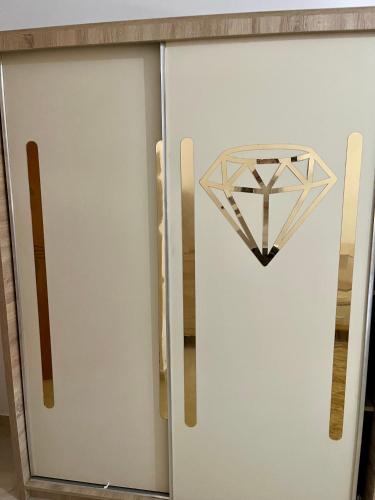a metal cabinet with a diamond on the door at Appartement doré in Tangier