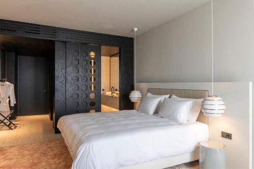 a bedroom with a large white bed with white pillows at Radisson Collection The National Hotel, Brussels in Zaventem