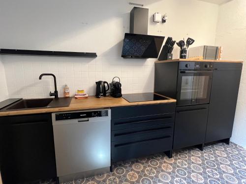 a kitchen with a sink and a dishwasher at Timos Dahoam 93qm Balkon und familienfreundlich in Nesselwang