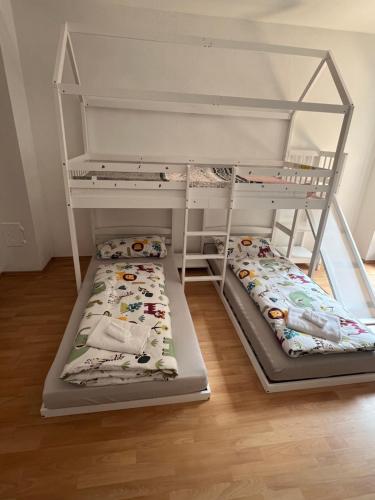 two bunk beds sitting in a room with at Timos Dahoam 93qm Balkon und familienfreundlich in Nesselwang