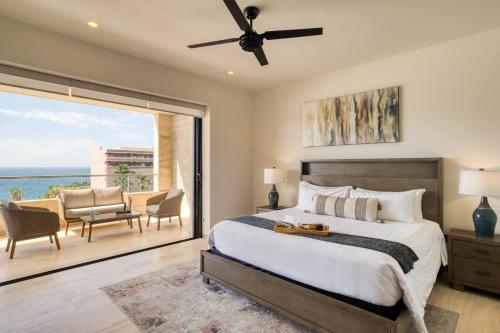 a bedroom with a bed and a view of the ocean at For couples, petfriendly 2 BR ocean view 18 4pax in Cabo San Lucas