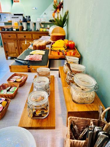 a kitchen with several wooden tables with food on them at Vila Bardot in Barra do Sahy