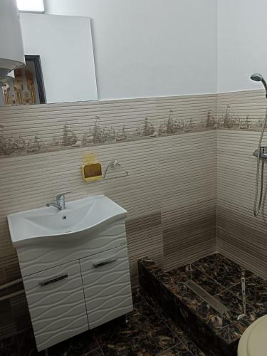 a bathroom with a sink and a shower at Seven Apartament in Mangalia