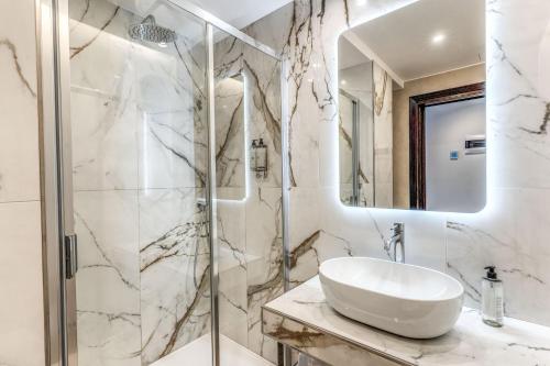 a bathroom with a sink and a shower at Hotel Castel Vecchio in Castel Gandolfo