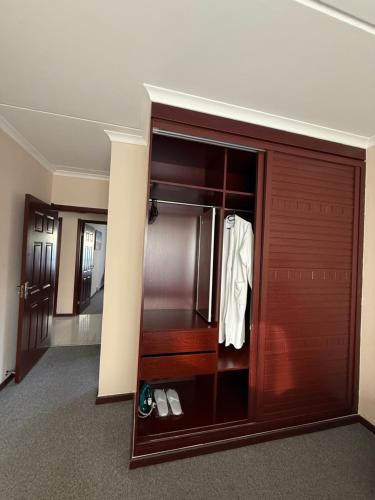 a room with a closet with a wooden door at 25 Lillies in Rustenburg