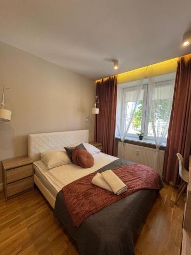 a bedroom with a large bed with two pillows on it at Family & Business Elegant Apartments KCK ul Astronautów Centrum Downtown - 3 Bedroom, Bath with Hydromassage, Parking in Kielce