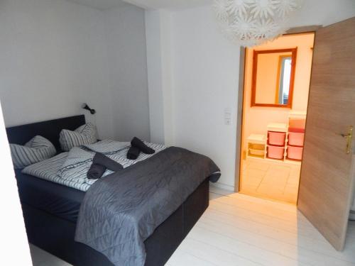 a bedroom with a bed and a door to a room at Hotel Neptuns Ankerplatz in Cuxhaven