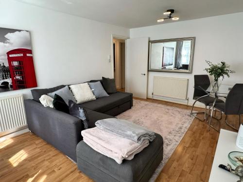 a living room with a couch and a table at Luxury 1 Bed Tower Bridge in London