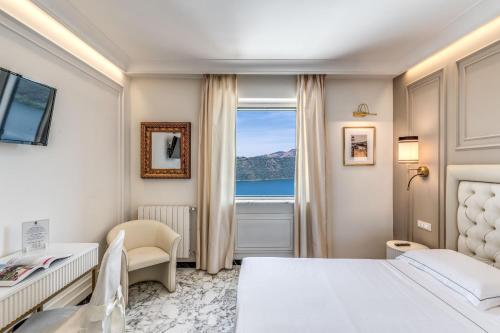 a hotel room with a bed and a window at Hotel Castel Vecchio in Castel Gandolfo