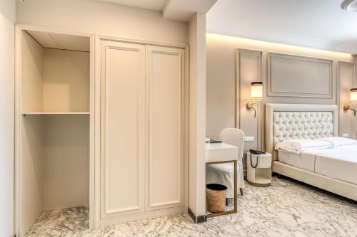 a small bedroom with a bed and a closet at Hotel Castel Vecchio in Castel Gandolfo