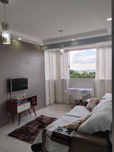 a bedroom with a large bed and a television at Apartamento privativo com garagem in Brasilia