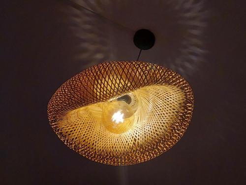 a large yellow light hanging from a ceiling at Residence Gentil in Saint Gabriel