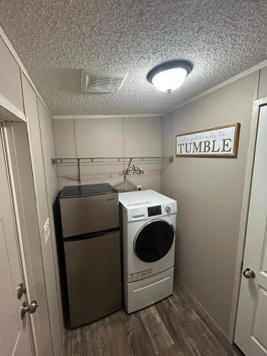 a small kitchen with a washer and dryer in it at Cozy river front lookout in Bullhead City