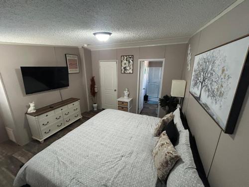 a bedroom with a bed and a flat screen tv at Cozy river front lookout in Bullhead City