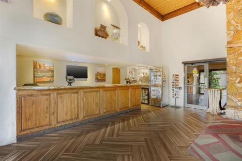 a large room with wooden cabinets and a television at Best Western Plus Arroyo Roble Hotel & Creekside Villas in Sedona