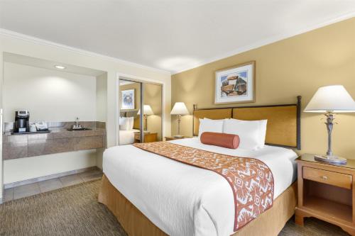 a hotel room with a large bed and a bathroom at Best Western Plus Arroyo Roble Hotel & Creekside Villas in Sedona
