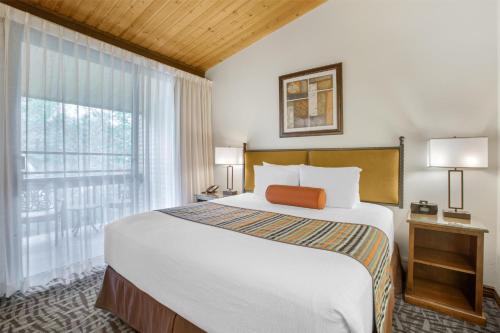 a bedroom with a large bed and a large window at Best Western Plus Arroyo Roble Hotel & Creekside Villas in Sedona
