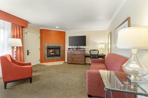 a living room with a couch and a fireplace at Best Western Plus Arroyo Roble Hotel & Creekside Villas in Sedona