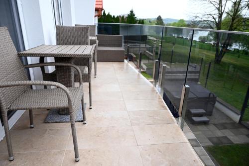 a patio with chairs and a table on a balcony at Tófény Őrségi Vendégház in Zalalövő