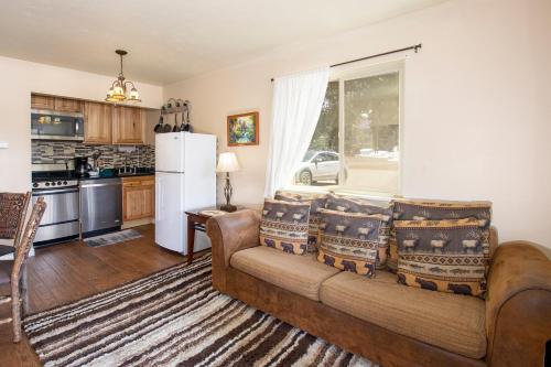 a living room with a couch and a kitchen at Hi Country Haus Unit 0406 in Winter Park