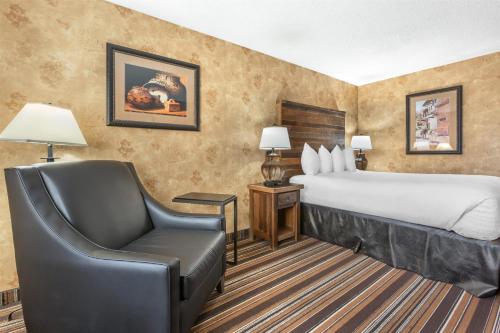 a hotel room with a bed and a chair at Best Western Plus Inn of Santa Fe in Santa Fe