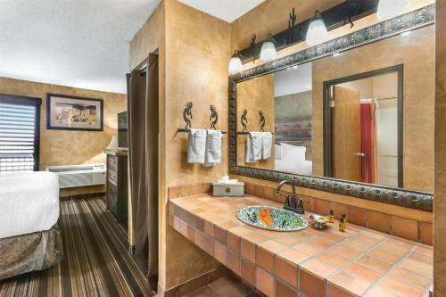 a bathroom with a sink and a mirror at Best Western Plus Inn of Santa Fe in Santa Fe