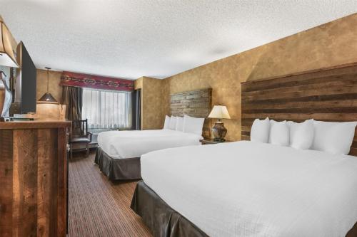 a hotel room with two beds and a television at Best Western Plus Inn of Santa Fe in Santa Fe