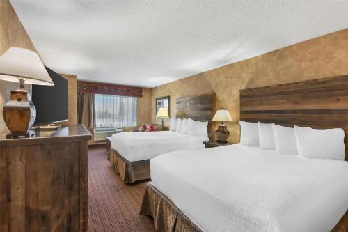 a hotel room with two beds and a television at Best Western Plus Inn of Santa Fe in Santa Fe