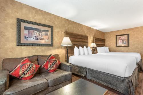 a hotel room with a bed and a couch at Best Western Plus Inn of Santa Fe in Santa Fe