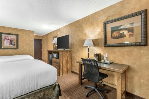 a hotel room with a bed and a desk at Best Western Plus Inn of Santa Fe in Santa Fe