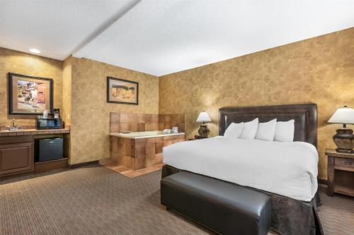a hotel room with a bed and a bath tub at Best Western Plus Inn of Santa Fe in Santa Fe