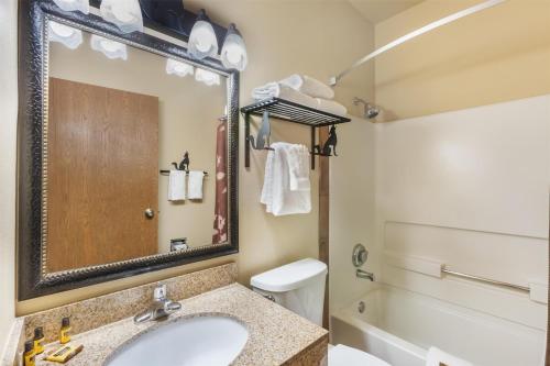 a bathroom with a sink and a toilet and a mirror at Best Western Plus Inn of Santa Fe in Santa Fe