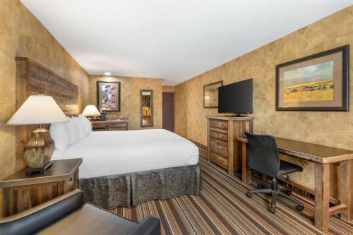 a hotel room with a bed and a desk at Best Western Plus Inn of Santa Fe in Santa Fe