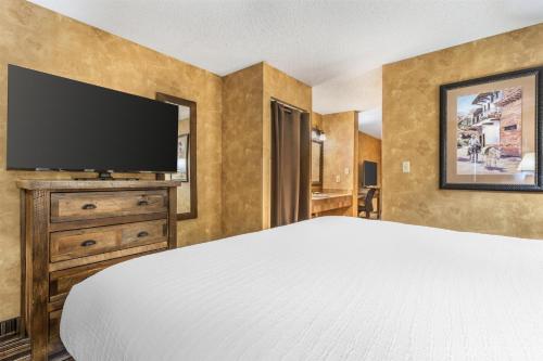 a bedroom with a bed and a flat screen tv at Best Western Plus Inn of Santa Fe in Santa Fe