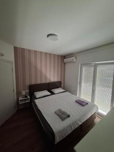 a bedroom with a bed with two towels on it at VilaMihaela in Skopje