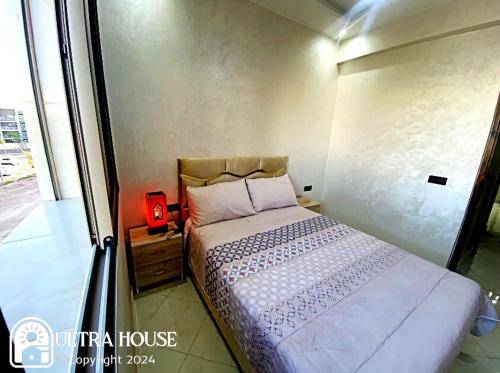 a small bedroom with a bed and a window at Prime Location, Budget Friendly Studio in Central 