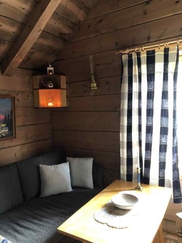 a small room with a table and a couch at Stall Rygg Mountain Cottage, Gloppen in Rygg