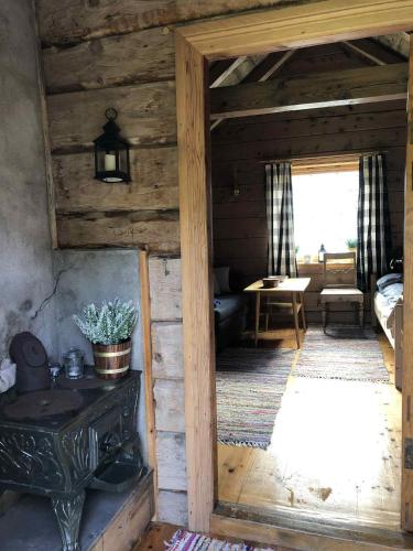 a room in a wooden cabin with a wooden door at Stall Rygg Mountain Cottage, Gloppen in Rygg