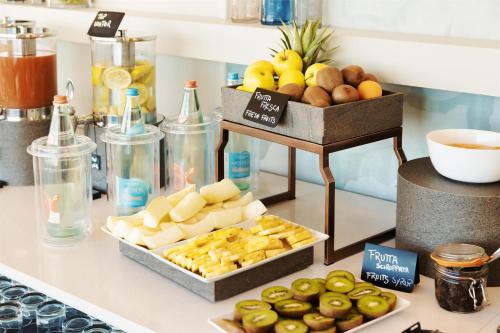 a buffet with apples and other fruits on a counter at Best Western Hotel Nazionale in Sanremo