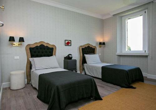 a bedroom with two beds and a window at Villa Chloe in Potenza Picena