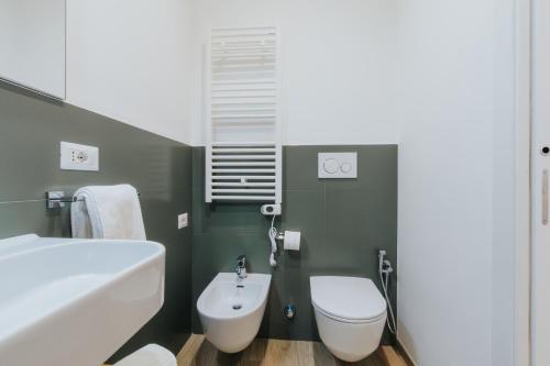 a bathroom with a white toilet and a sink at Dimora Favia in Bari
