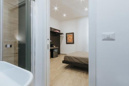 a room with a bed and a door to a bedroom at Dimora Favia in Bari