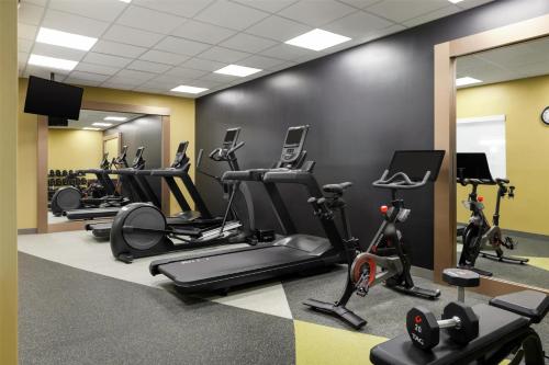 a gym with treadmills and elliptical machines at Hilton Garden Inn Riverhead in Riverhead
