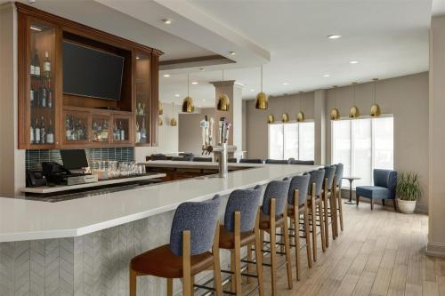 a bar with a row of chairs in a room at Hilton Garden Inn Riverhead in Riverhead