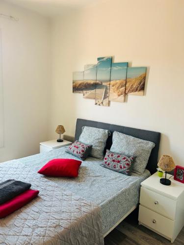a bedroom with a bed with red pillows on it at Casa Red Riviera in Juan-les-Pins
