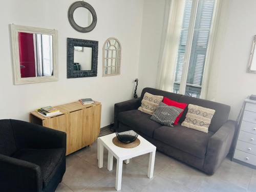 a living room with a couch and a table at Casa Red Riviera in Juan-les-Pins