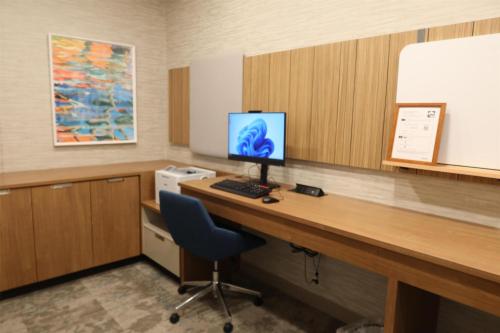 a room with a desk with a computer on it at Hilton Garden Inn Lakewood in Lakewood