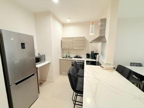 a kitchen with a refrigerator and a counter top at Minissy luxury Serviced Apartment in Moka
